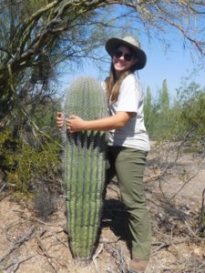 Carolyn Harper stands with saguaros.