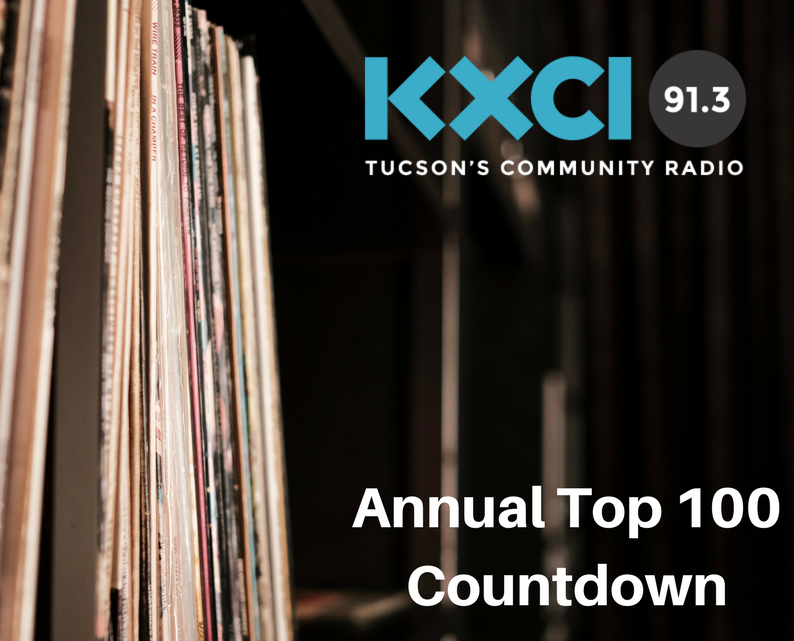 A shelf of albums taken at KXCI's Congress Street Studios with KXCI Logo that says Annual Top 100 Countdown.